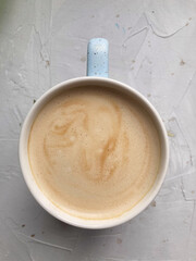 cup of coffee on concrete table, top view