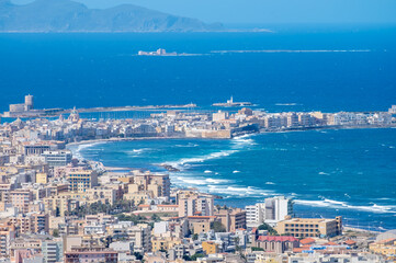 Fototapeta premium View from heights of Erice to scenic coastal roads, Trapani’s salt pans and olive groves, panoramic view on Trapany and Mediterranean sea, travel destination in Italy