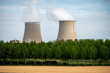Fototapeta premium View on cooling towers of nuclear power plant thermal power station in which heat source is nuclear reactor, France, Europe, cheap energy source