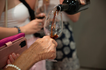 Tasting of Banyuls AOC aged natural sweet grand cru Banyuls fortified dessert wine from old vines from slopes Pyrenees in Roussillon, France made in glass jar Dame Jeanne or demijohn