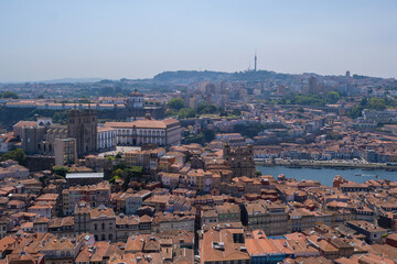Aerial panoramic view of Porto, Portugal, featuring the historic cathedral, medieval rooftops, and typical hosuses of the Ribeira neighborghood