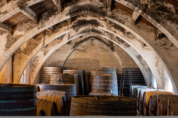 Old oak barrels for aging of natural sweet red grand cru wine Banyuls fortified dessert wine from...