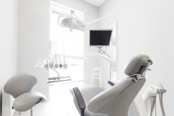 Modern dental practice. Professional chair and other accessories for doctor in room, medical light