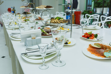 Elegant buffet table featuring an array of delicious dishes in a bright, modern venue during a lively gathering