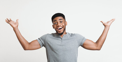 Fototapeta premium Excited african-american man winner raising his hands with great happiness, winning game, having success, being glad to achieve his goals. Victory and triumph concept