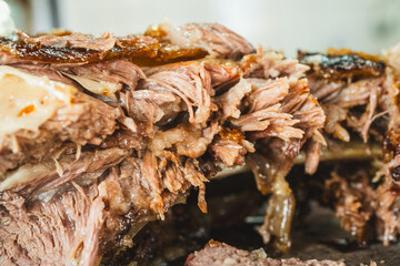 Extreme close up of a perfectly grilled beef rib, sliced to reveal the incredibly juicy and tender interior. Meat fibers and smoky crust visible.