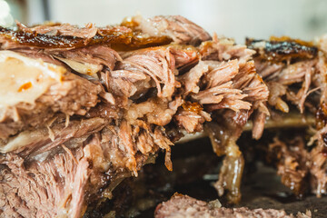 Extreme close up of a perfectly grilled beef rib, sliced to reveal the incredibly juicy and tender interior. Meat fibers and smoky crust visible.