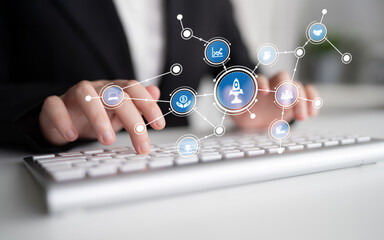 A professional individual types on a keyboard, illustrating the idea of business growth and innovation, surrounded by digital icons representing various technology concepts. Tessel