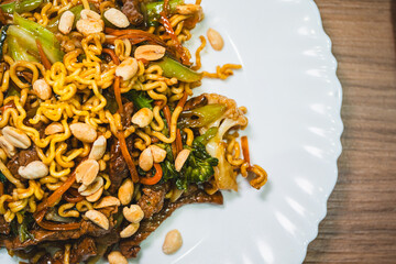 Delicious Japanese yakisoba stir-fried noodles with fresh vegetables on a plate. Savory, glossy and perfectly cooked. Ideal for Asian food content.