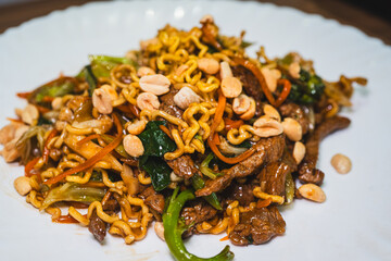 Delicious Japanese yakisoba stir-fried noodles with fresh vegetables on a plate. Savory, glossy and perfectly cooked. Ideal for Asian food content.