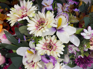 Vibrant bouquet of artificial silk flowers featuring white, pink, and purple blossoms