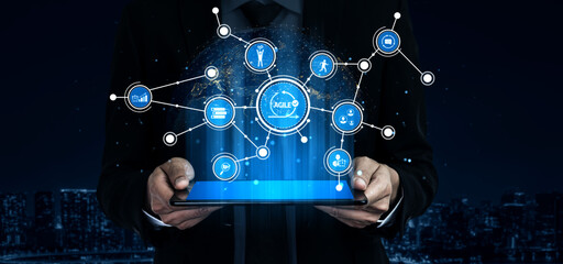 A businessman stands in an urban setting, holding a tablet that displays digital connections and technologies, symbolizing innovation and global networking trends. Tessel