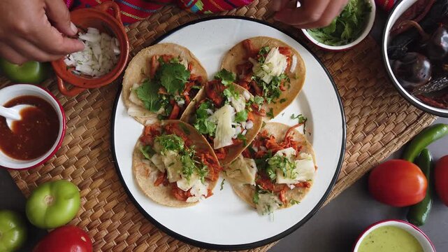 Mexican woman hands preparing tacos al pastor and eating mexican food in Mexico Latin America