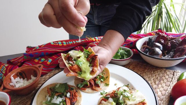 Mexican woman hands preparing tacos al pastor and eating mexican food in Mexico Latin America