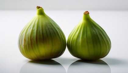 Obraz premium two green figs on a white surface