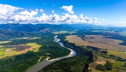 Obraz premium High-angle view of a winding river flowing through a landscape of mountains, forests, and farmland