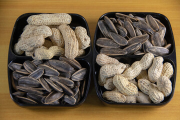 Photograph, Top view of mixed salted peanuts and kuaci (sunflower seeds) served in a plate for...