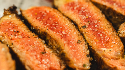 Juicy sliced steak cooked medium rare, seasoned with coarse barbecue salt. Perfect for food blogs and restaurant menus.