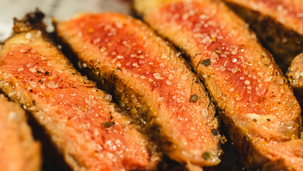 Juicy sliced steak cooked medium rare, seasoned with coarse barbecue salt. Perfect for food blogs and restaurant menus.