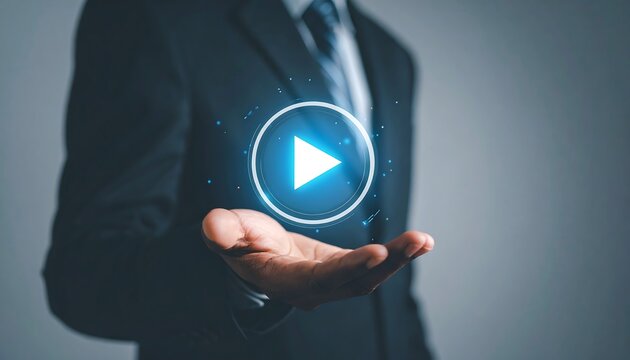 Businessman holding holographic play button representing futuristic media technology - Powered by Adobe