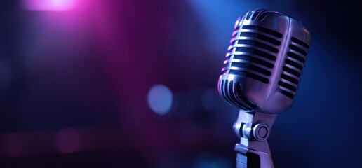 Vintage microphone on a concert stage, glowing with vibrant pink and blue spotlight effects, creating an atmospheric background