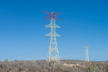 Components of an electrical power system for substations and transmission lines in Cabo San Lucas, Baja California Sur, Mexico. transmission line tower in the desert