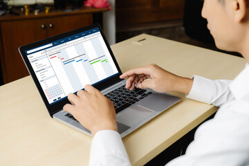 Project planning software for modish business project management on the computer screen showing timeline chart of the team project