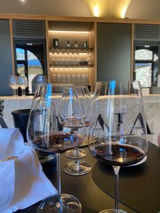 Red wine tasting in Tuscany with multiple glasses on table