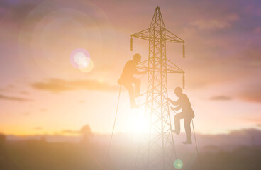 Electrical Linemen Climbing Transmission Tower at Sunset