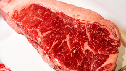 Beautiful fresh raw beef steaks prepared and seasoned, ready for the barbecue grill. Perfect for food content.