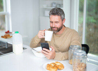 Healthy food concept. Healthy lifestyle. Mature Man with fresh vegetables and fruits for a healthy meal. Man eat fresh salad with organic ingredients. Healthy kitchen.