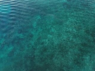 Top down aerial view of Malakal lagoon in Palau, turquoise ocean water and coral reef texture background.Ngemelachel