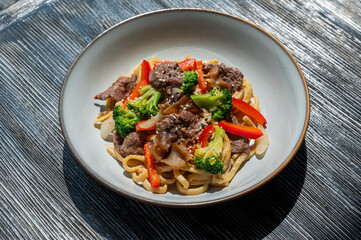 Top view of pasta with beef and broccoli. 