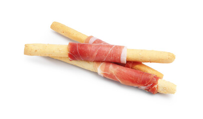 Delicious grissini sticks with prosciutto isolated on white