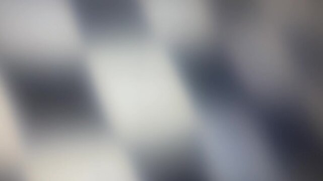Checkered Flag black and white, abstract background of light blur, concept of winner or arrival of race