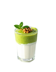 Layered green smoothie topped with walnuts and mint