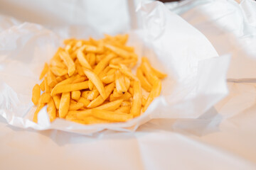 Hot chips with chicken salt in open bundle of white butchers paper