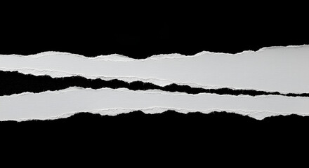 Torn paper edges on black background conveying separation and contrast aesthetically