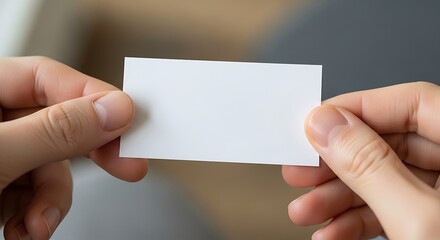 Person holding up a blank, white business card for promotional mockup