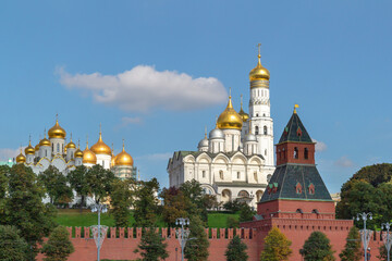 Moscow kremlin red brick wall and orthodox cathedral with bell tower