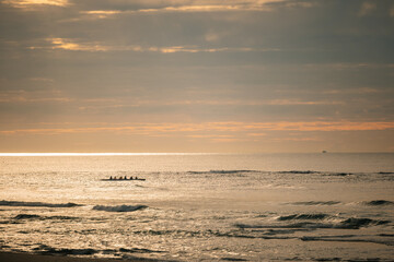 Silhouette of rowing club on the water for early morning practice