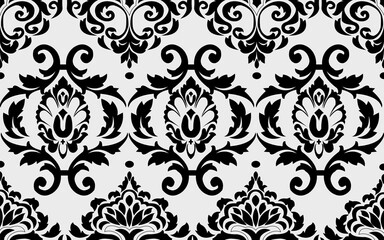 Damask wallpaper. A seamless background. Black and white texture. Floral ornament.