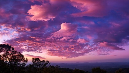 Fototapeta premium Majestic Clouds In Shades Of Pink And Purple Create Dreamy Sky At Sunset Evoking Tranquility
