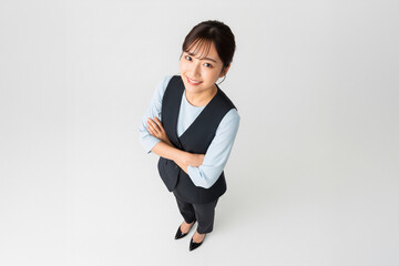 High Angle Shot of Asian Hotel Receptionist Smiling with Arms Crossed