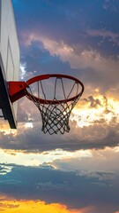 Basketball Hoop against Dramatic Sunset Cloudscape with Golden Light Sky View