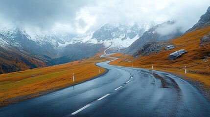 Panoramic View of Grossglockner Alpine Road in Alps: Curvy Winding Mountain Road with Snow-Capped Peaks, Autumn Foliage, and Wet Pavement for Travel, Wallpaper, Outdoor Adventure Designs