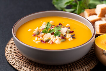 Butternut squash pumpkin soup with granola in a bowl, Homemade food in autumn season