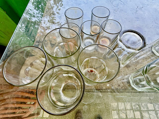 A table with a bunch of glasses and cups on it
