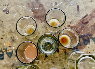 A table with five glasses of different sizes and shapes