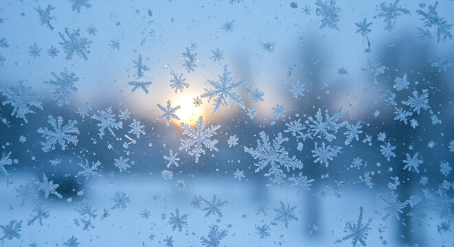 Snowflakes on a frosted window with a sunset in winter   - Powered by Adobe